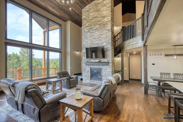 20746 Monte Carlo Rd, Lead, SD 57754 - living area with high vaulted ceiling, dark wood finished floors, wood ceiling, and a stone fireplace