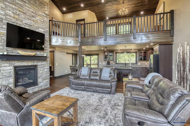 20746 Monte Carlo Rd, Lead, SD 57754 - living room with wooden ceiling, high vaulted ceiling, dark wood-style floors, and a stone fireplace