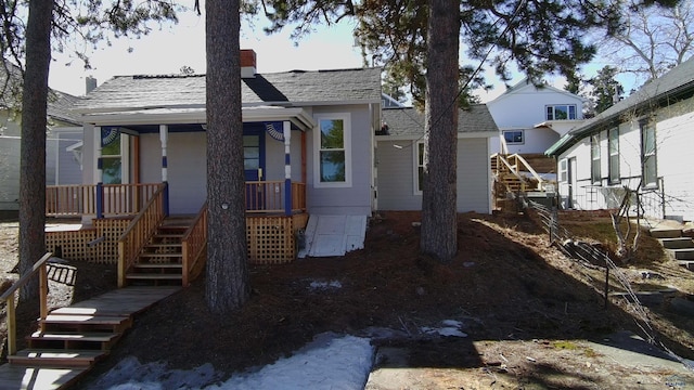 807 Addie St Unit 807Upper, Addie, Lead, SD 57754 - bungalow-style home featuring stairway, covered porch, a chimney, and a shingled roof
