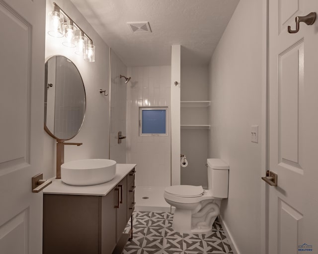 807 Addie St Unit 807Upper, Addie, Lead, SD 57754 - bathroom featuring vanity, a tile shower, and a textured ceiling