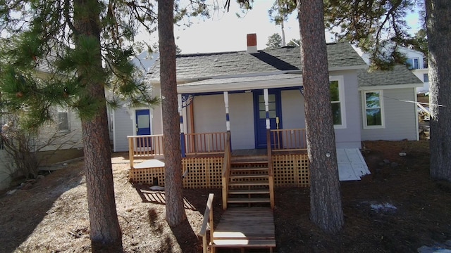 807 Addie St Unit 807Upper, Addie, Lead, SD 57754 - rear view of property with a porch, a shingled roof, and a chimney