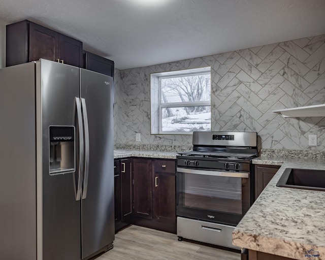 807 Addie St Unit 807Upper, Addie, Lead, SD 57754 - kitchen with stainless steel appliances, decorative backsplash, light wood-style floors, and dark brown cabinetry
