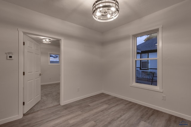 807 Addie St Unit 807Upper, Addie, Lead, SD 57754 - empty room with wood finished floors and a chandelier