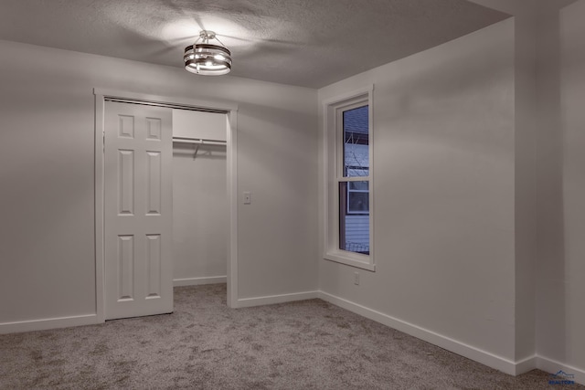 807 Addie St Unit 807Upper, Addie, Lead, SD 57754 - unfurnished bedroom with carpet flooring, a textured ceiling, and a closet