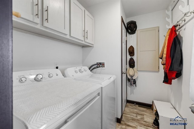 28085 Hargins Rd, Hot Springs, SD 57747 - washroom with cabinet space, washing machine and clothes dryer, and light wood-type flooring