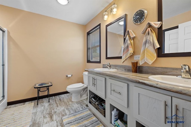 28085 Hargins Rd, Hot Springs, SD 57747 - full bathroom featuring double vanity, wood finished floors, and a shower with door