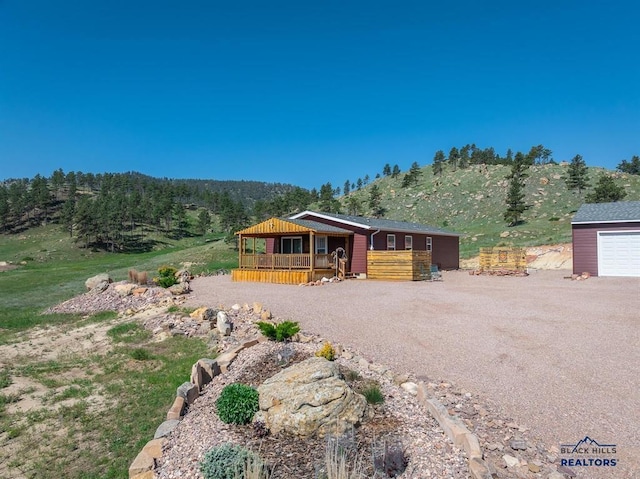 28085 Hargins Rd, Hot Springs, SD 57747 - view of front facade featuring a deck and driveway