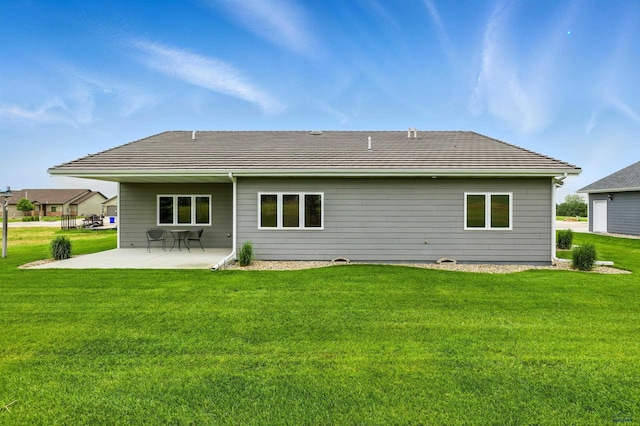 4519 Jolly Ln, Rapid City, SD 57701 - back of house featuring a patio, a lawn, and a tile roof