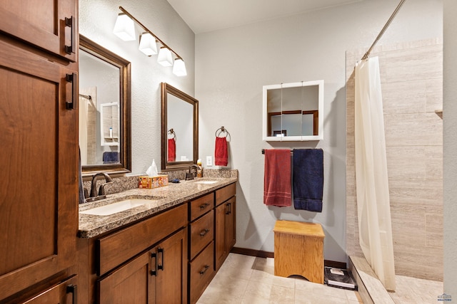 4519 Jolly Ln, Rapid City, SD 57701 - bathroom with tiled shower, double vanity, and tile patterned floors