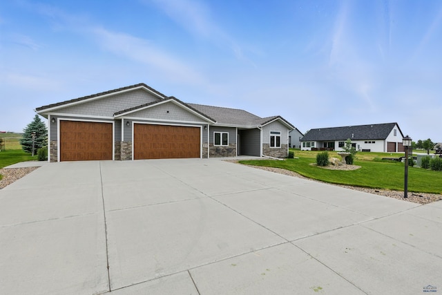 4519 Jolly Ln, Rapid City, SD 57701 - craftsman-style home featuring stone siding, a garage, a front lawn, and concrete driveway