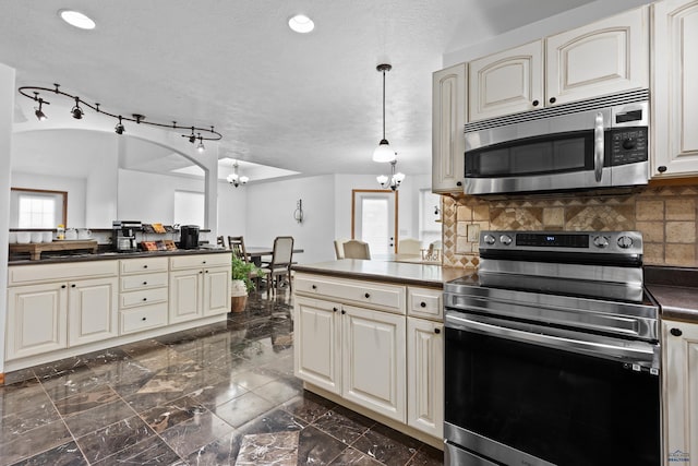 6401 Mountain Meadow Rd, Black Hawk, SD 57718 - kitchen featuring stainless steel appliances, a chandelier, dark countertops, a peninsula, and cream cabinets