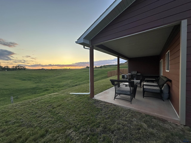 215 Aurora Ave, Spearfish, SD 57783 - yard at dusk featuring a patio area, a yard, and an outdoor hangout area