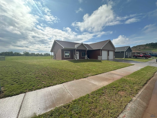 215 Aurora Ave, Spearfish, SD 57783 - single story home with driveway, an attached garage, a front yard, and board and batten siding