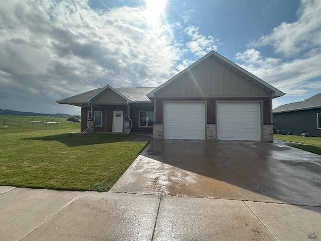 215 Aurora Ave, Spearfish, SD 57783 - view of front of house with driveway, a garage, and board and batten siding