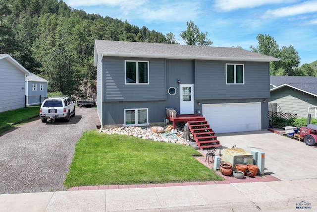20 Mcmasters Dr, Deadwood, SD 57732 - split foyer home with driveway, an attached garage, and a shingled roof