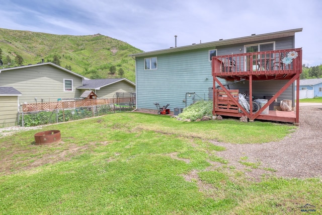 20 Mcmasters Dr, Deadwood, SD 57732 - back of property with a deck with mountain view and an outdoor fire pit