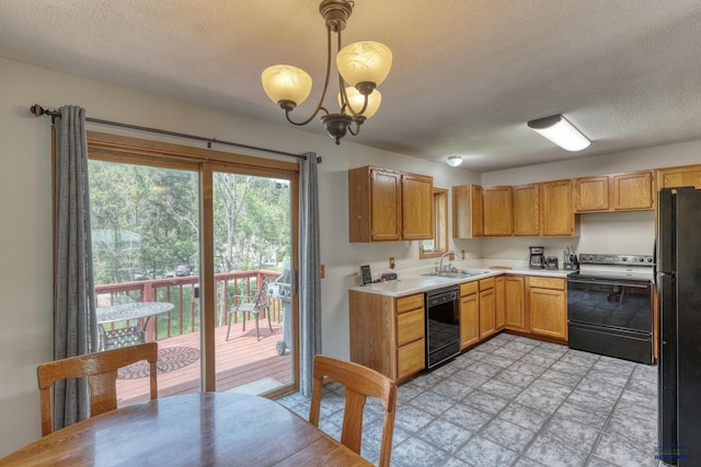 20 Mcmasters Dr, Deadwood, SD 57732 - kitchen featuring black appliances, a textured ceiling, light countertops, a chandelier, and decorative light fixtures