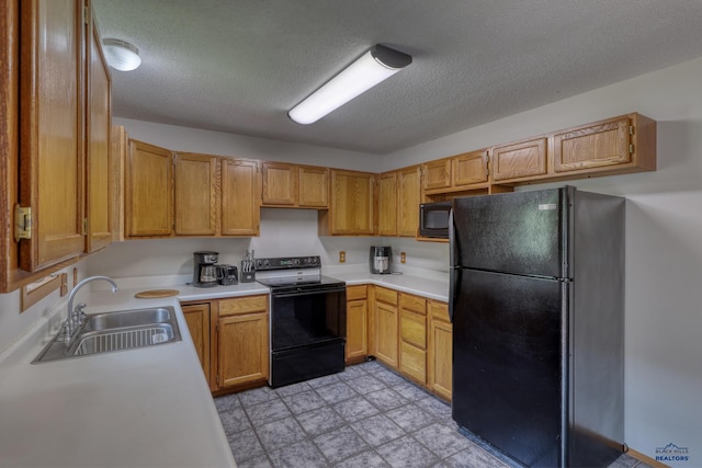 20 Mcmasters Dr, Deadwood, SD 57732 - kitchen with black appliances, a textured ceiling, and light countertops