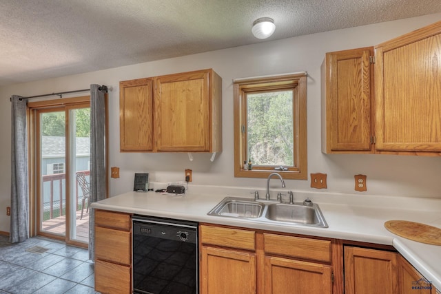 20 Mcmasters Dr, Deadwood, SD 57732 - kitchen featuring black dishwasher, healthy amount of natural light, light countertops, and a textured ceiling