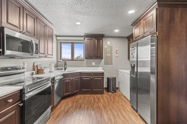 5642 Bob Ln, Black Hawk, SD 57718 - kitchen with stainless steel appliances, a textured ceiling, dark wood-style flooring, light countertops, and recessed lighting