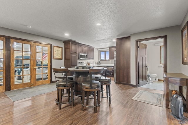 5642 Bob Ln, Black Hawk, SD 57718 - dining room featuring a textured ceiling, wood finished floors, recessed lighting, and french doors