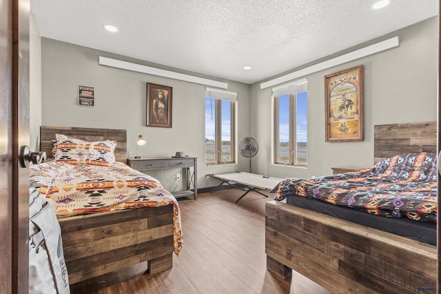 5642 Bob Ln, Black Hawk, SD 57718 - bedroom featuring a textured ceiling, wood finished floors, and recessed lighting