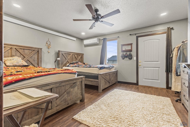 5642 Bob Ln, Black Hawk, SD 57718 - bedroom with a wall mounted air conditioner, wood finished floors, a textured ceiling, a ceiling fan, and recessed lighting