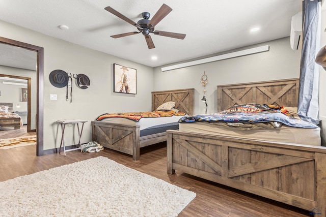 5642 Bob Ln, Black Hawk, SD 57718 - bedroom featuring wood finished floors, ceiling fan, a wall unit AC, and recessed lighting