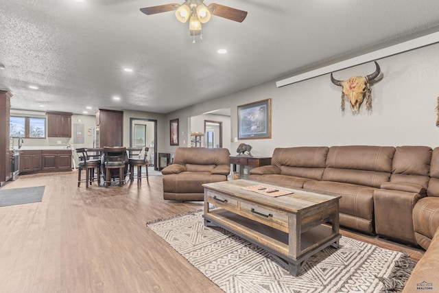 5642 Bob Ln, Black Hawk, SD 57718 - living area with light wood-style flooring, a textured ceiling, recessed lighting, and ceiling fan