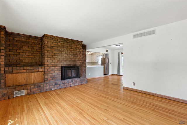 4340 Timothy, Rapid City, SD 57702 - unfurnished living room featuring light wood finished floors and a fireplace