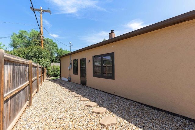 4340 Timothy, Rapid City, SD 57702 - view of home's exterior with stucco siding and a chimney