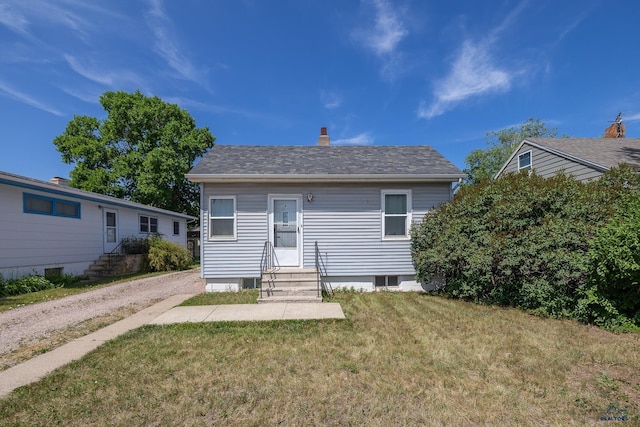911 Haines Ave, Rapid City, SD 57701 - rear view of house with entry steps, a lawn, and a chimney