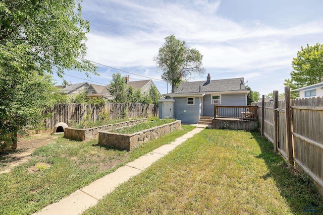 911 Haines Ave, Rapid City, SD 57701 - fenced backyard featuring a garden and a wooden deck