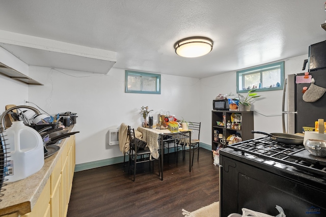 911 Haines Ave, Rapid City, SD 57701 - kitchen featuring black gas stove, dark wood-type flooring, light countertops, and freestanding refrigerator