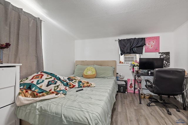 911 Haines Ave, Rapid City, SD 57701 - bedroom with wood finished floors, cooling unit, a textured ceiling, and an office area