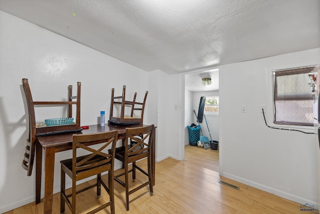 911 Haines Ave, Rapid City, SD 57701 - dining area with light wood-style flooring and a textured ceiling
