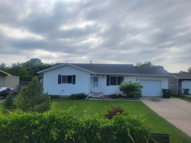 1685 Dorothy Dr, Rapid City, SD 57703 - ranch-style home with concrete driveway, a garage, a front lawn, and a shingled roof