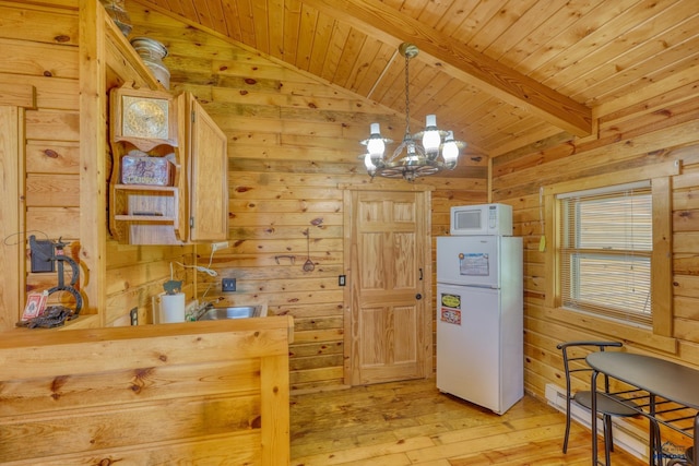 20813 Legends Ln, Sturgis, SD 57785 - kitchen with white appliances, wood walls, light wood finished floors, wood ceiling, and a chandelier