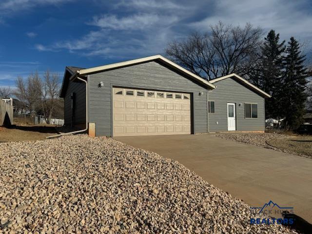 3226 W Rapid, Rapid City, SD 57702 - view of front facade featuring concrete driveway and a garage