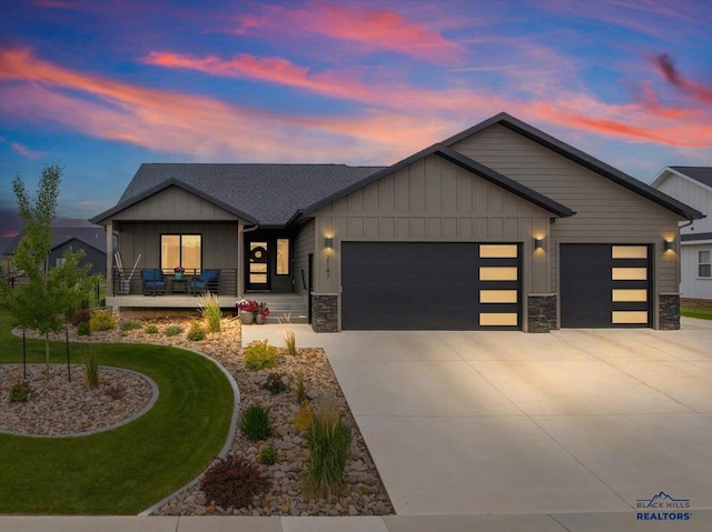 2147 Talisker Ave, Spearfish, SD 57783 - view of front of house featuring an attached garage, board and batten siding, stone siding, and driveway