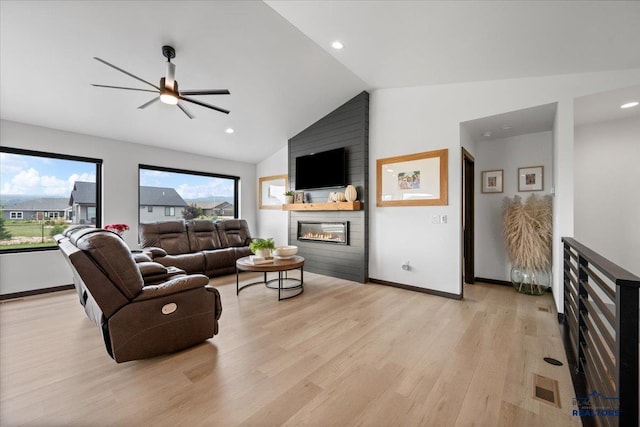 2147 Talisker Ave, Spearfish, SD 57783 - living area with a fireplace, light wood finished floors, vaulted ceiling, a ceiling fan, and recessed lighting