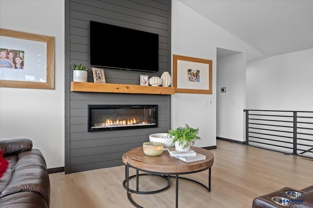 2147 Talisker Ave, Spearfish, SD 57783 - living room featuring wood finished floors, a fireplace, and lofted ceiling