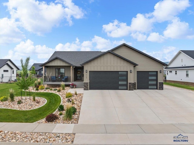 2147 Talisker Ave, Spearfish, SD 57783 - view of front of property featuring an attached garage, concrete driveway, board and batten siding, covered porch, and a front yard