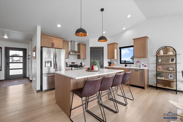 2147 Talisker Ave, Spearfish, SD 57783 - kitchen with appliances with stainless steel finishes, wall chimney exhaust hood, backsplash, light countertops, and lofted ceiling