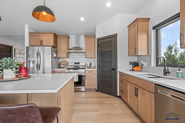 2147 Talisker Ave, Spearfish, SD 57783 - kitchen featuring stainless steel appliances, wall chimney exhaust hood, decorative backsplash, light wood-style floors, and light countertops