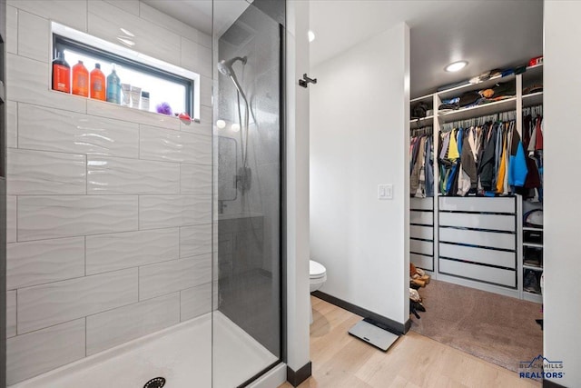 2147 Talisker Ave, Spearfish, SD 57783 - bathroom featuring a shower stall, wood finished floors, a walk in closet, and recessed lighting