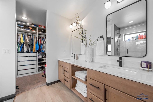 2147 Talisker Ave, Spearfish, SD 57783 - full bath with wood finished floors, double vanity, a stall shower, and a walk in closet