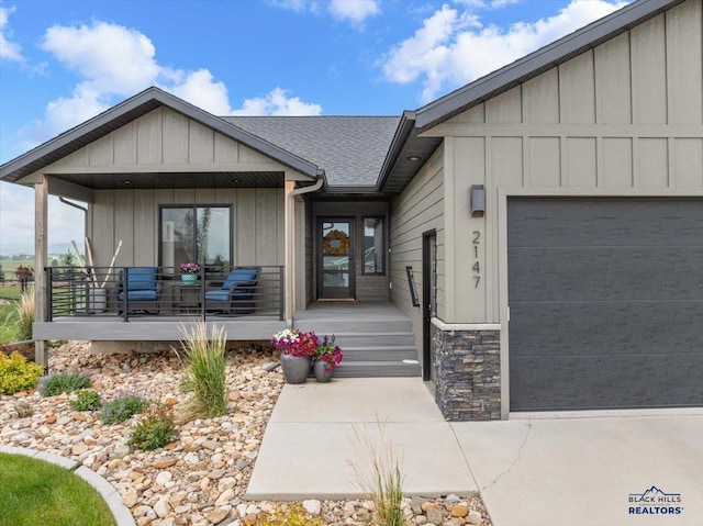 2147 Talisker Ave, Spearfish, SD 57783 - contemporary house with board and batten siding, a porch, stone siding, and an attached garage