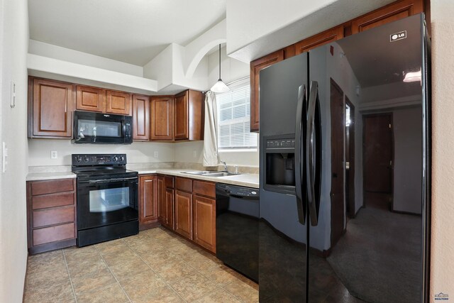 756 Earleen St Unit D, Rapid City, SD 57701 - kitchen with black appliances, light countertops, brown cabinets, and hanging light fixtures
