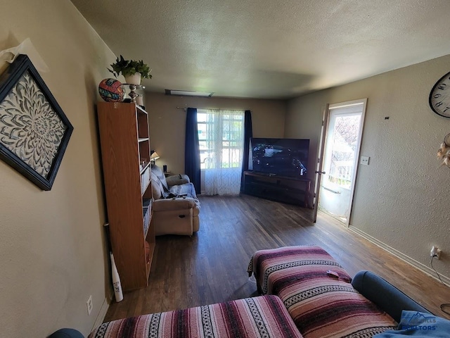 217 E Monroe St, Rapid City, SD 57701 - living room with plenty of natural light, wood finished floors, a textured ceiling, and a textured wall